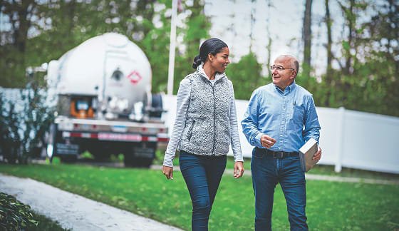 People walking by propane truck